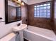 Cozy bathroom with pedestal sink, tile floor and tiled shower-bathtub combo at 639 S Alpha Ave, Brownsburg, IN 46112