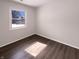 A bedroom featuring wood-look floors and a window that allows for natural light at 639 S Alpha Ave, Brownsburg, IN 46112