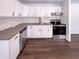Modern kitchen with stainless steel appliances, subway tile backsplash, and clean white cabinets at 639 S Alpha Ave, Brownsburg, IN 46112