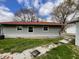 View of the rear of the house with grey siding, white trim, and stepping stones at 639 S Alpha Ave, Brownsburg, IN 46112