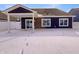 A beautiful outdoor covered patio space extends to the yard with snow, offering a serene space for relaxation and entertaining at 6812 W Wintergreen Ct, McCordsville, IN 46055