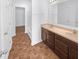 Well-lit bathroom features a double sink vanity with dark cabinets and a full bath, with neutral brown flooring at 6812 W Wintergreen Ct, McCordsville, IN 46055