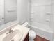 Clean bathroom featuring a white vanity sink, toilet, and full bathtub with shower, offering functionality at 6812 W Wintergreen Ct, McCordsville, IN 46055