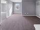 Spacious bedroom with gray walls and plush carpet provides ample space and natural light from the window at 6812 W Wintergreen Ct, McCordsville, IN 46055