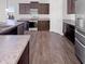 Well-equipped kitchen with modern stainless steel appliances, ample counter space, and dark wood cabinets at 6812 W Wintergreen Ct, McCordsville, IN 46055