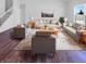 Bright living room featuring modern furniture, a stylish rug, and large windows offering plenty of natural light at 6812 W Wintergreen Ct, McCordsville, IN 46055
