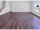 Spacious living room with hard surface floors, ample natural light from a large window, and a staircase at 6812 W Wintergreen Ct, McCordsville, IN 46055
