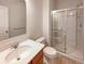 Bathroom features a modern vanity, toilet, and glass enclosed walk-in shower at 6830 Shooting Star Dr, Whitestown, IN 46075