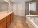 Well-lit bathroom featuring a double vanity, a separate shower, and a soaking tub at 6830 Shooting Star Dr, Whitestown, IN 46075