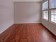 Unfurnished bedroom with hardwood floors and bright windows showcasing a neighborhood view at 6830 Shooting Star Dr, Whitestown, IN 46075