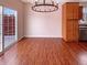 Bright dining area featuring hardwood floors, stylish chandelier, and sliding glass doors to the outside at 6830 Shooting Star Dr, Whitestown, IN 46075