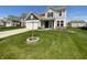 Charming two-story home featuring a well-maintained lawn, attached garage, and lovely curb appeal at 6830 Shooting Star Dr, Whitestown, IN 46075