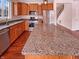 Modern kitchen featuring granite countertops, stainless steel appliances, and ample cabinet space at 6830 Shooting Star Dr, Whitestown, IN 46075