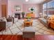 Cozy living room with pink walls, a fireplace, plush seating, and an elegant rug at 6830 Shooting Star Dr, Whitestown, IN 46075