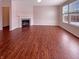 Bright living room with beautiful wood floors, a fireplace, and large windows for ample natural light at 6830 Shooting Star Dr, Whitestown, IN 46075