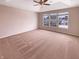 Spacious main bedroom with a tray ceiling, a ceiling fan, and a large window at 6830 Shooting Star Dr, Whitestown, IN 46075