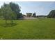 Expansive grassy backyard with a weeping willow, showcasing landscaping and open space at 7152 Old Morgantown Rd, Martinsville, IN 46151