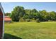 Expansive backyard featuring a mix of lush green grass and wooded areas, offering privacy and natural beauty at 7152 Old Morgantown Rd, Martinsville, IN 46151
