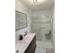 Modern bathroom with a glass enclosed shower with bench, double sink vanity and contemporary fixtures at 7152 Old Morgantown Rd, Martinsville, IN 46151