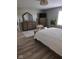 This bedroom boasts luxury vinyl flooring, a dresser with mirror and a modern television for entertainment at 7152 Old Morgantown Rd, Martinsville, IN 46151