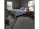 Bright bedroom with large windows, wood look floors, a queen bed, and a modern decorative lamp at 7152 Old Morgantown Rd, Martinsville, IN 46151