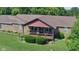Charming brick home with a covered porch and beautiful landscaping surrounded by a lush green lawn at 7152 Old Morgantown Rd, Martinsville, IN 46151