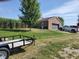 Home exterior featuring a brick facade, garage, and driveway, surrounded by lush green grass and mature trees at 7152 Old Morgantown Rd, Martinsville, IN 46151