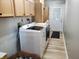 Convenient laundry room with a white washer and dryer, and light wood cabinets for storage at 7152 Old Morgantown Rd, Martinsville, IN 46151