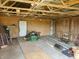 Interior view of outbuilding featuring a riding lawn mower and plywood flooring at 7152 Old Morgantown Rd, Martinsville, IN 46151