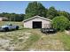 Exterior of outbuilding with a truck parked nearby and greenery surrounding the gravel area at 7152 Old Morgantown Rd, Martinsville, IN 46151