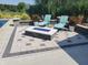 Outdoor patio features a fire pit with blue glass, lounge chairs and plants on a sunny day at 7152 Old Morgantown Rd, Martinsville, IN 46151
