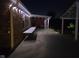 Evening view of the covered patio area, with decorative lighting and outdoor dining space at 7152 Old Morgantown Rd, Martinsville, IN 46151