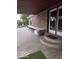 Covered outdoor patio with steps to doors, large table, and view of the backyard at 7152 Old Morgantown Rd, Martinsville, IN 46151