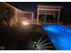 Evening shot of the pool, patio, and firepit area with accent lighting at 7152 Old Morgantown Rd, Martinsville, IN 46151