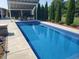 A beautiful in-ground pool in a private backyard with covered seating and mature trees at 7152 Old Morgantown Rd, Martinsville, IN 46151