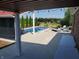 View of an inground pool, covered patio, outdoor fire pit and landscaping at 7152 Old Morgantown Rd, Martinsville, IN 46151