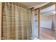 Bathroom featuring shower stall with curtain, wood shelving, and white trim at 724 E 199Th St, Westfield, IN 46074