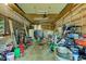 Large cluttered garage with concrete floors and wood beams at 724 E 199Th St, Westfield, IN 46074