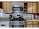 Well-equipped kitchen featuring stainless steel appliances and wood-look cabinetry at 724 E 199Th St, Westfield, IN 46074
