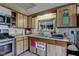 A warm, cozy kitchen featuring plentiful cabinet space, tile backsplash, and stainless steel appliances at 724 E 199Th St, Westfield, IN 46074