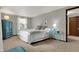 Comfortable bedroom with neutral walls, neutral carpet, queen-size bed and large windows with bright natural light at 7344 Monon Cir, Indianapolis, IN 46256