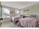 Cozy bedroom with two twin beds, bright windows, and neutral carpet flooring at 7344 Monon Cir, Indianapolis, IN 46256