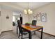 Elegant dining room featuring a modern chandelier and views into the living room at 7344 Monon Cir, Indianapolis, IN 46256