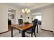 Cozy dining room featuring a modern chandelier and views into the living room at 7344 Monon Cir, Indianapolis, IN 46256