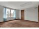 Neutral empty room with two windows letting in ample natural light and plush carpeting at 7344 Monon Cir, Indianapolis, IN 46256