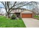 Charming two-story home featuring a brick facade, attached two-car garage and well-manicured lawn at 7344 Monon Cir, Indianapolis, IN 46256