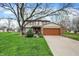 Charming two-story home featuring a brick facade, attached two-car garage and well-manicured lawn at 7344 Monon Cir, Indianapolis, IN 46256