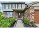 Inviting front porch with brick accents, cozy seating, and a well-maintained garden landscape at 7344 Monon Cir, Indianapolis, IN 46256
