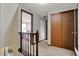 Upstairs hallway with wood railing, beige carpet, a bedroom view and natural light at 7344 Monon Cir, Indianapolis, IN 46256
