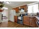 Functional kitchen featuring wood cabinets, black appliances, and durable flooring at 7344 Monon Cir, Indianapolis, IN 46256
